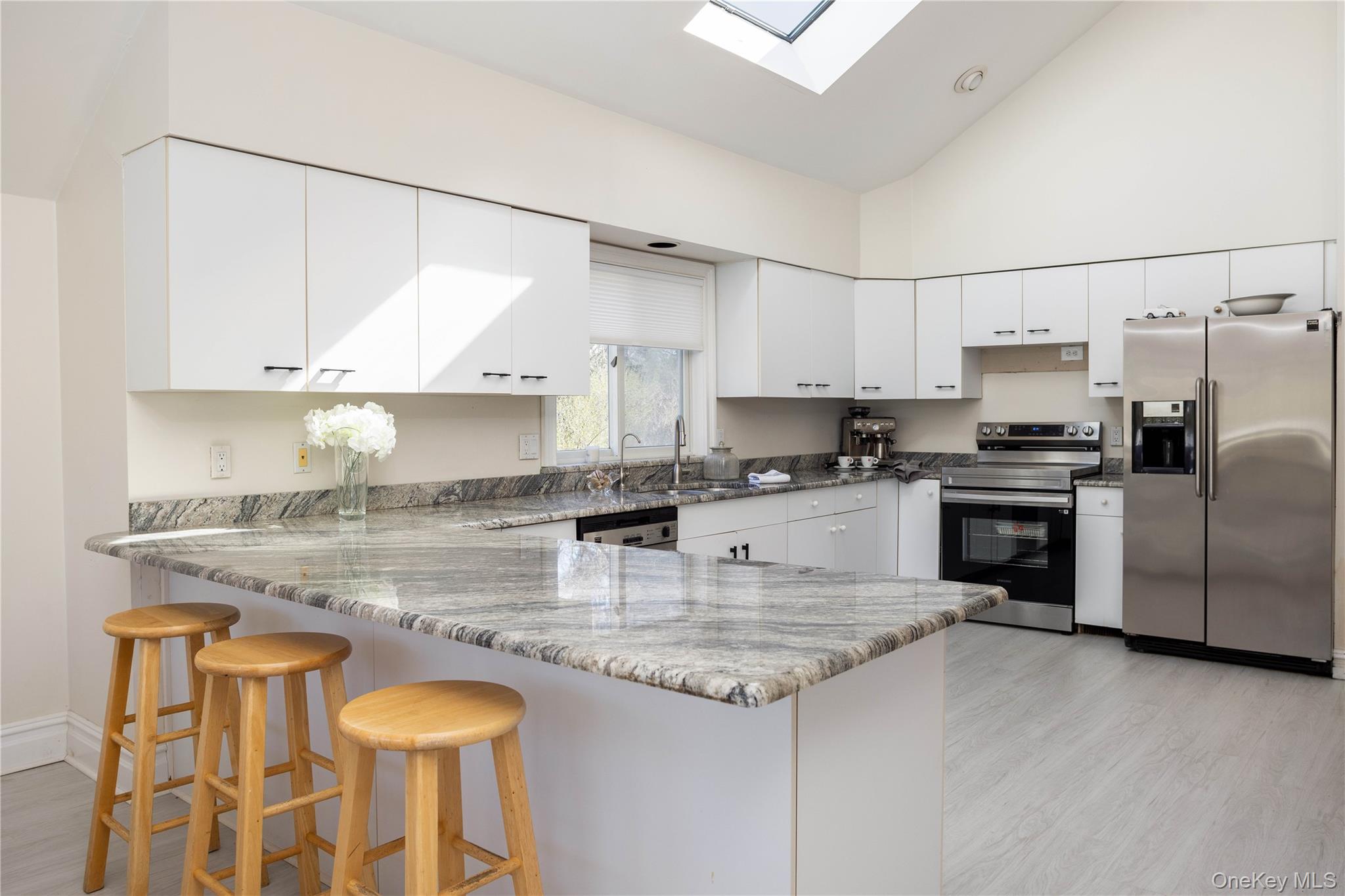 3 Clay Pit Road Remsenburg, NY 11960 - Photo 6 of 20 a kitchen with granite countertop a stove a sink and a refrigerator