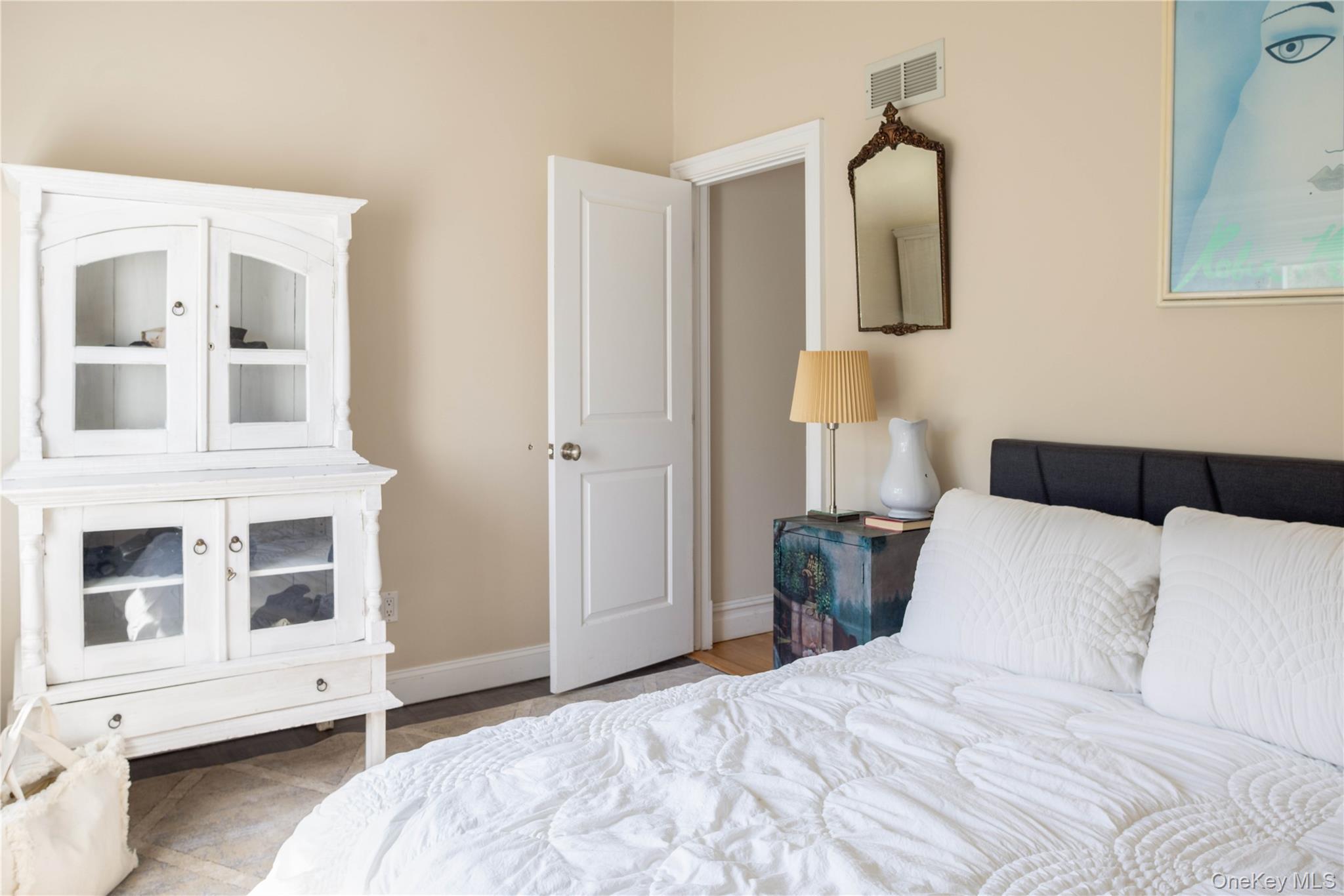 3 Clay Pit Road Remsenburg, NY 11960 - Photo 8 of 20 a bedroom with a large bed and a window