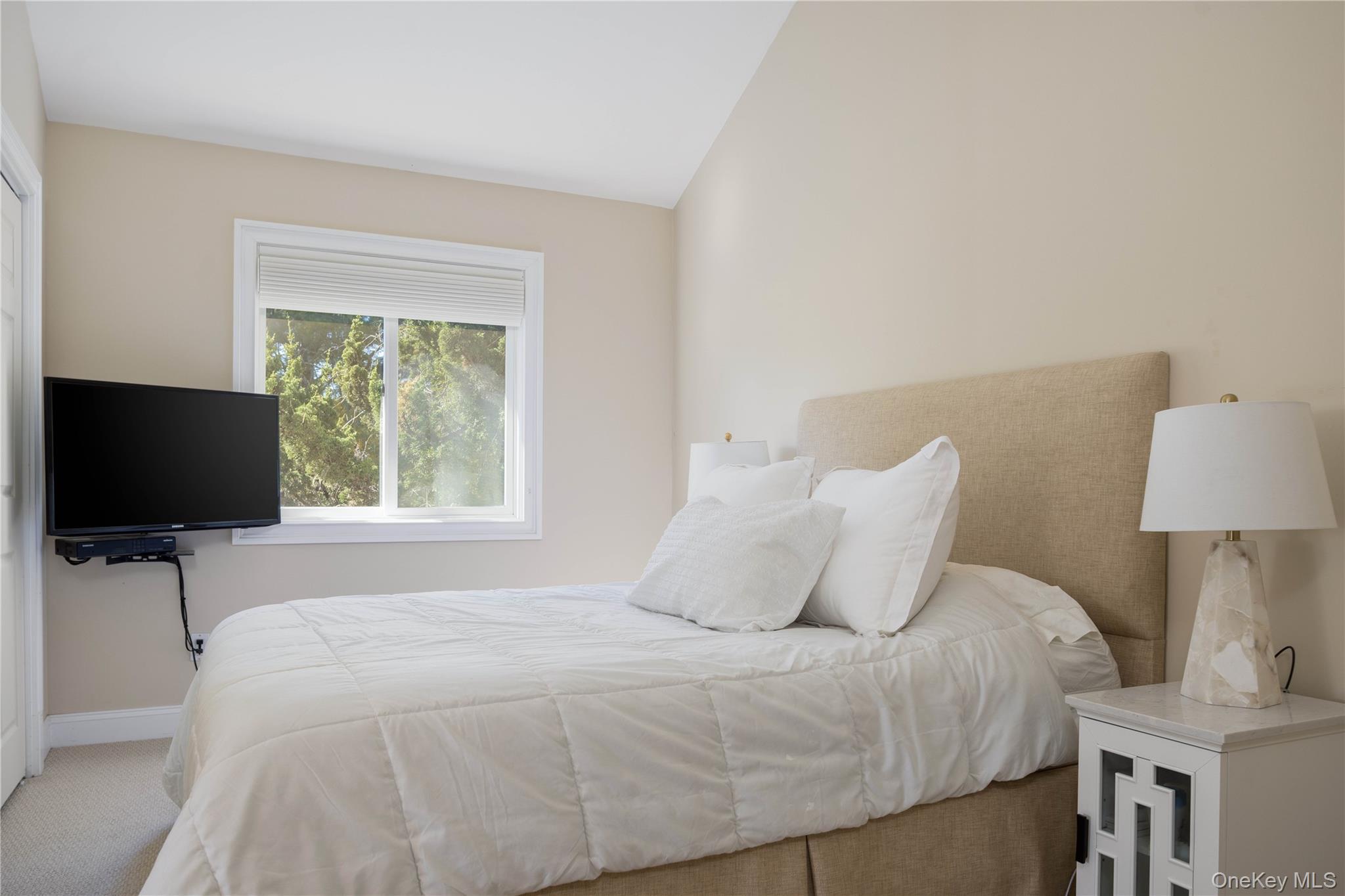 3 Clay Pit Road Remsenburg, NY 11960 - Photo 10 of 20 a bedroom with a bed and a flat screen tv