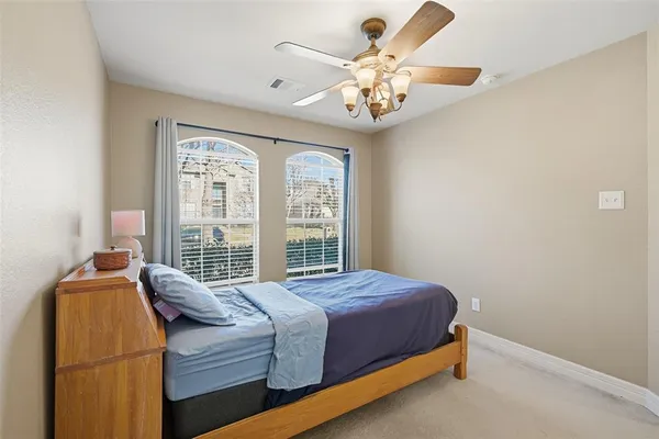 a bed sitting in a bedroom next to a window