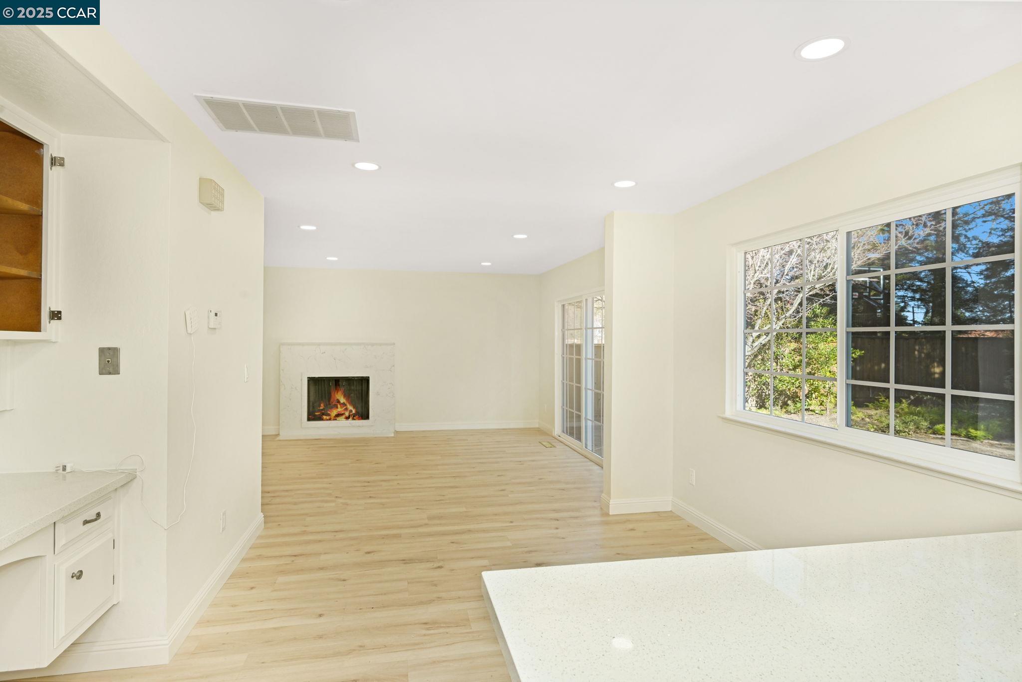 1181 Sunlight Circle Concord, CA 94518 - Photo 13 of 36 a view of an empty room with wooden floor and a window