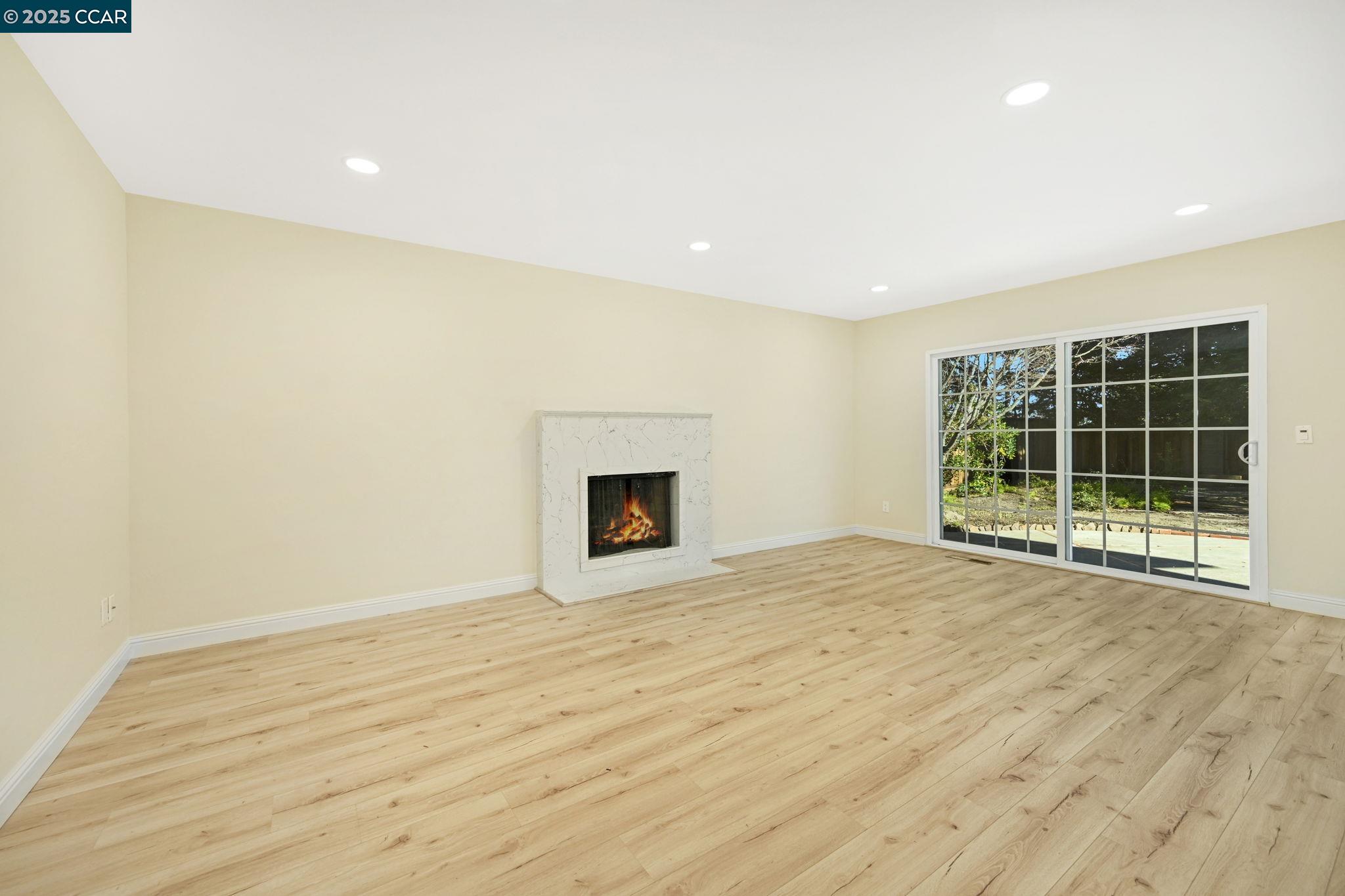 1181 Sunlight Circle Concord, CA 94518 - Photo 17 of 36 a view of an empty room with wooden floor and a window