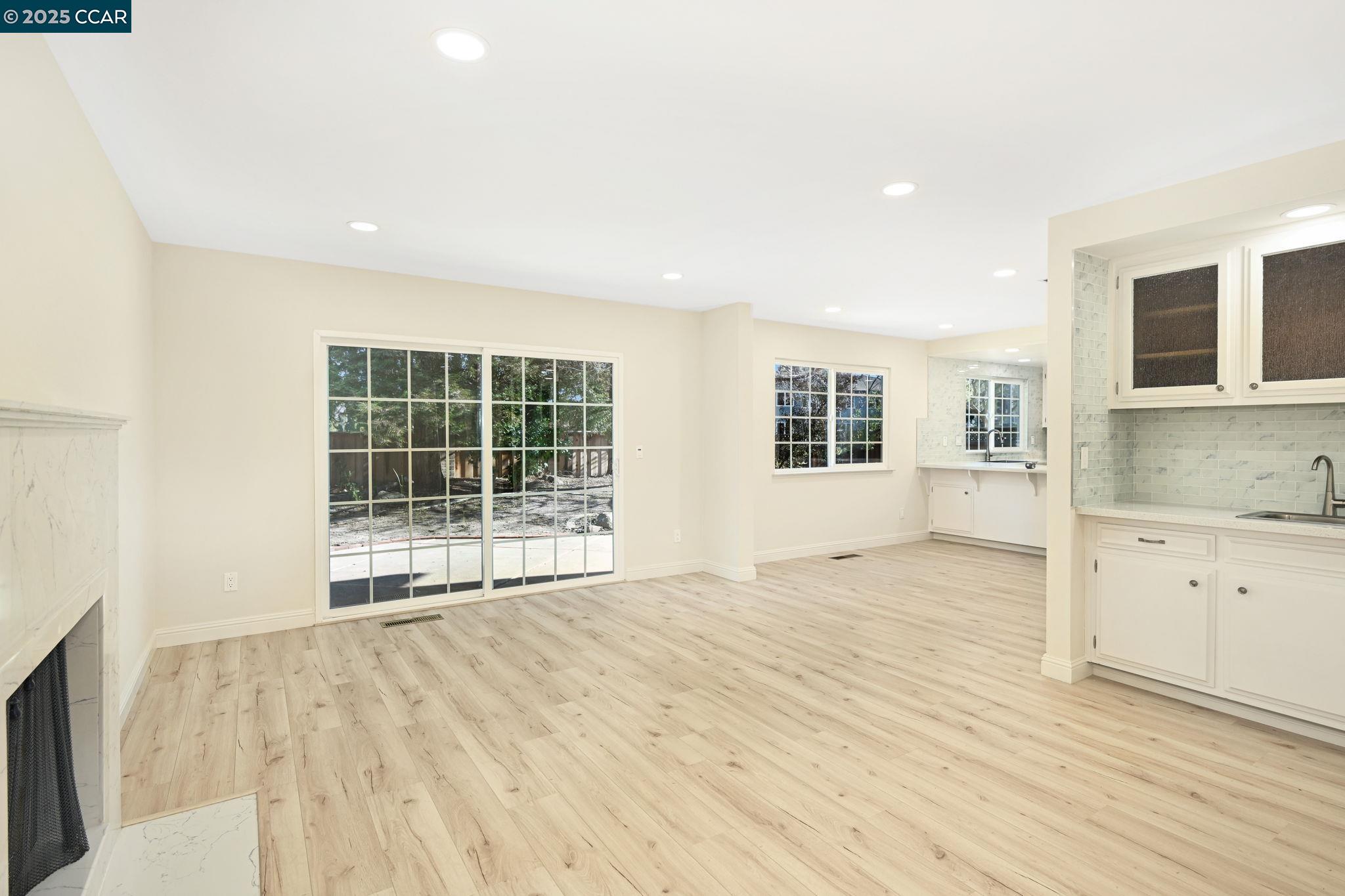 1181 Sunlight Circle Concord, CA 94518 - Photo 18 of 36 a view of an empty room with wooden floor and a window