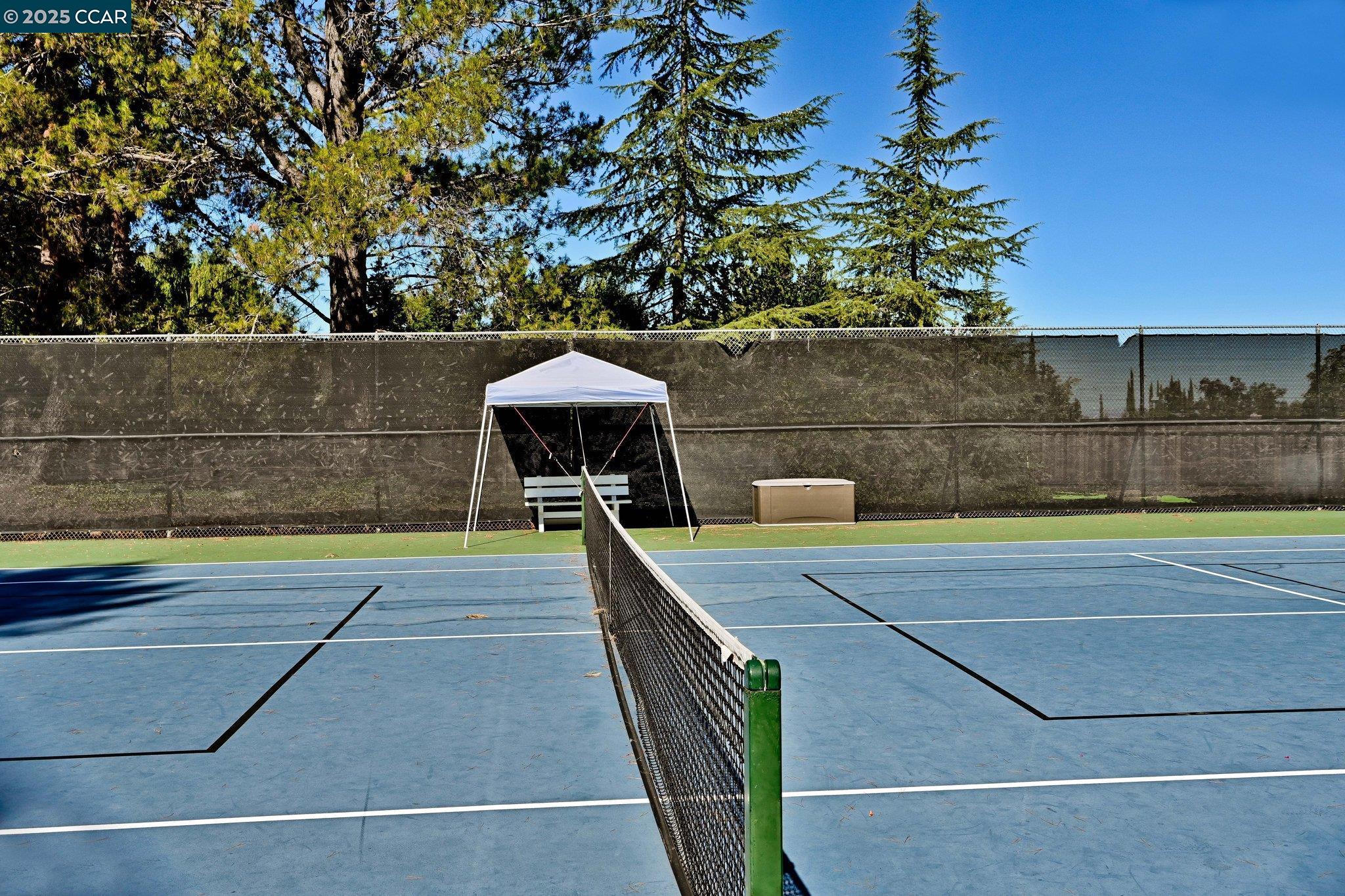 1181 Sunlight Circle Concord, CA 94518 - Photo 32 of 36 a view of a swimming pool with a bench and some trees