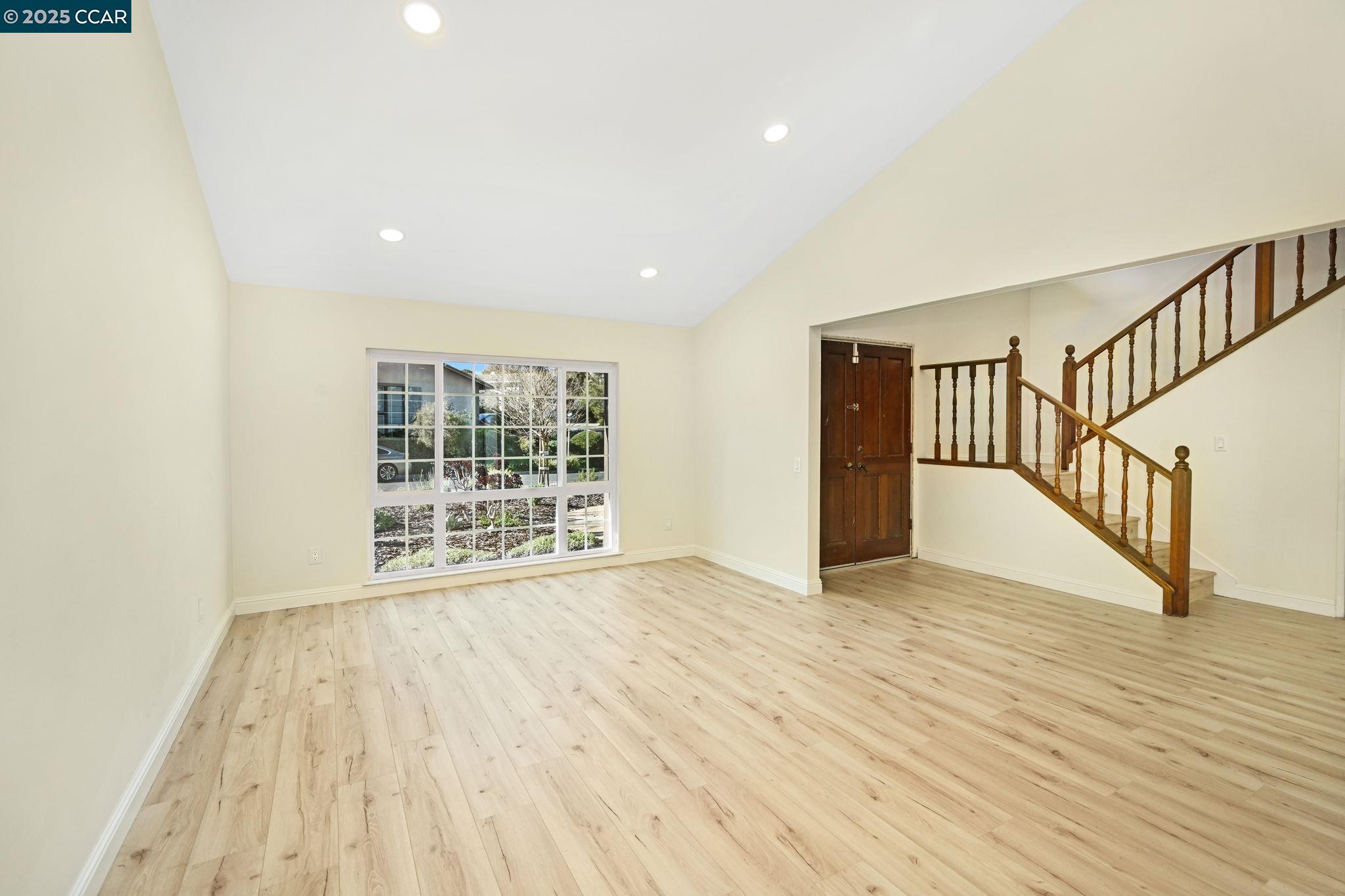 1181 Sunlight Circle Concord, CA 94518 - Photo 7 of 36 a view of an empty room with wooden floor and a window