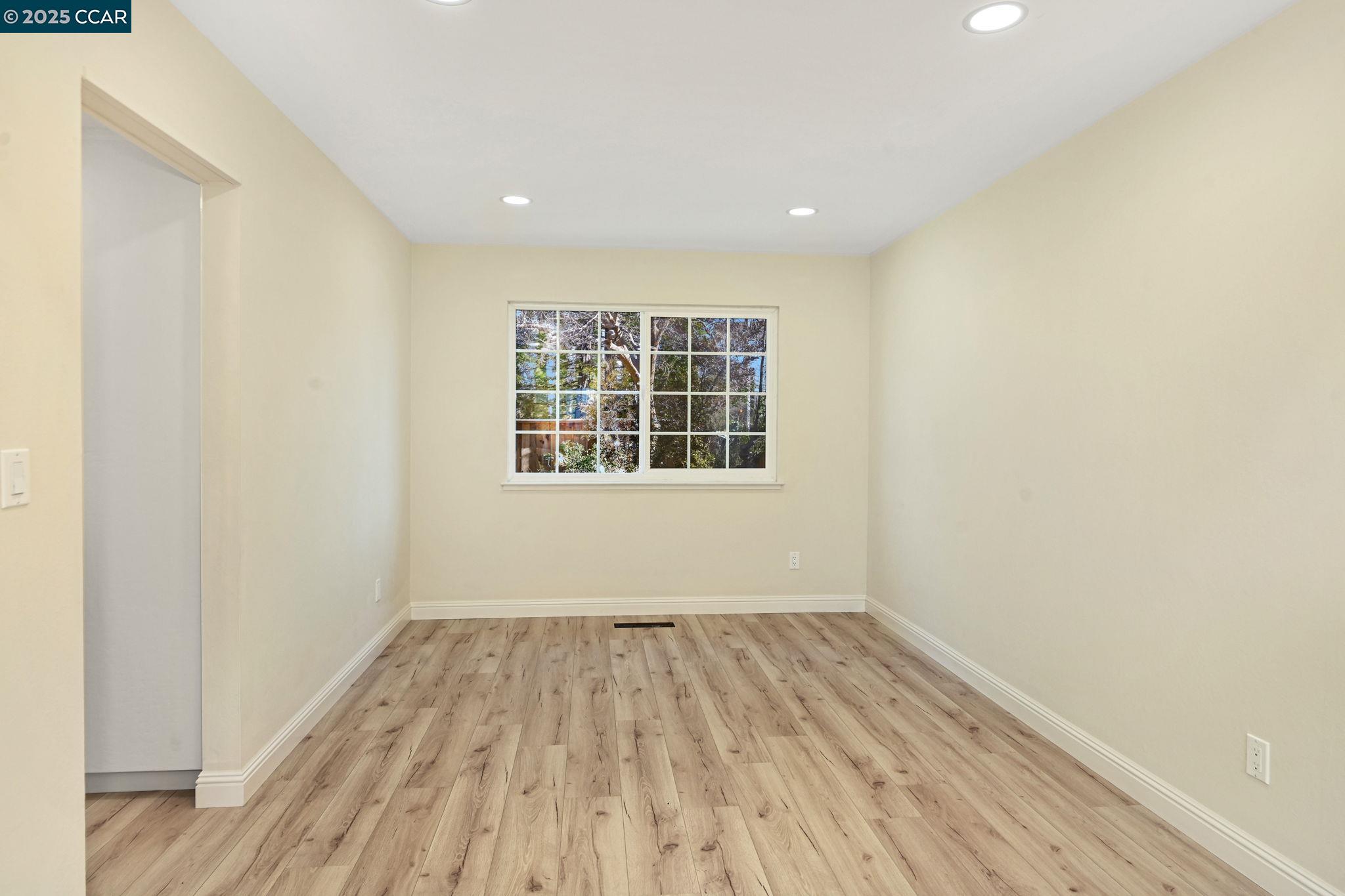 1181 Sunlight Circle Concord, CA 94518 - Photo 9 of 36 a view of empty room with wooden floor and fan