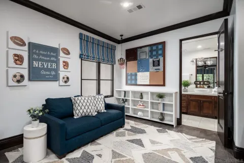 a room with furniture projector and screen