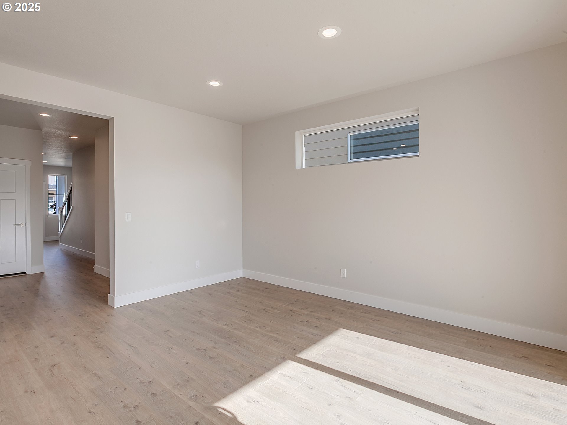 13858 Southwest 174th Avenue Tigard, OR 97140 - Photo 14 of 44 a view of an empty room with wooden floor and a bathroom