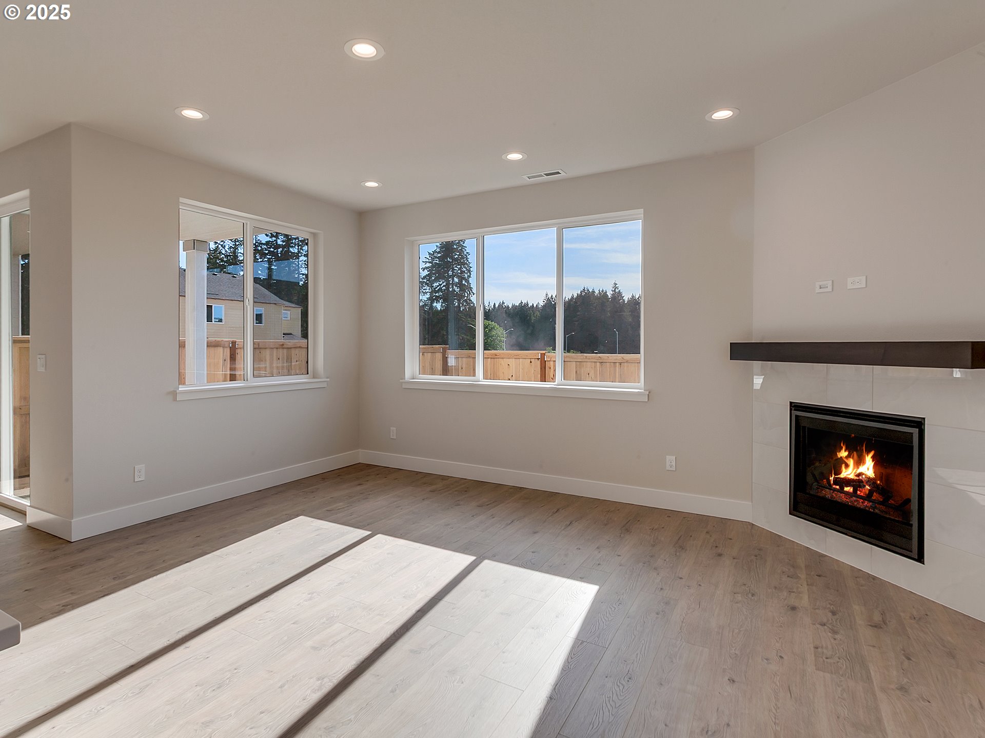 13858 Southwest 174th Avenue Tigard, OR 97140 - Photo 7 of 44 an empty room with windows and fireplace