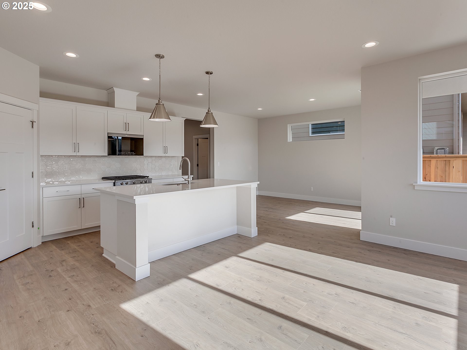 13858 Southwest 174th Avenue Tigard, OR 97140 - Photo 8 of 44 a kitchen with stainless steel appliances kitchen island granite countertop a sink a stove and a refrigerator