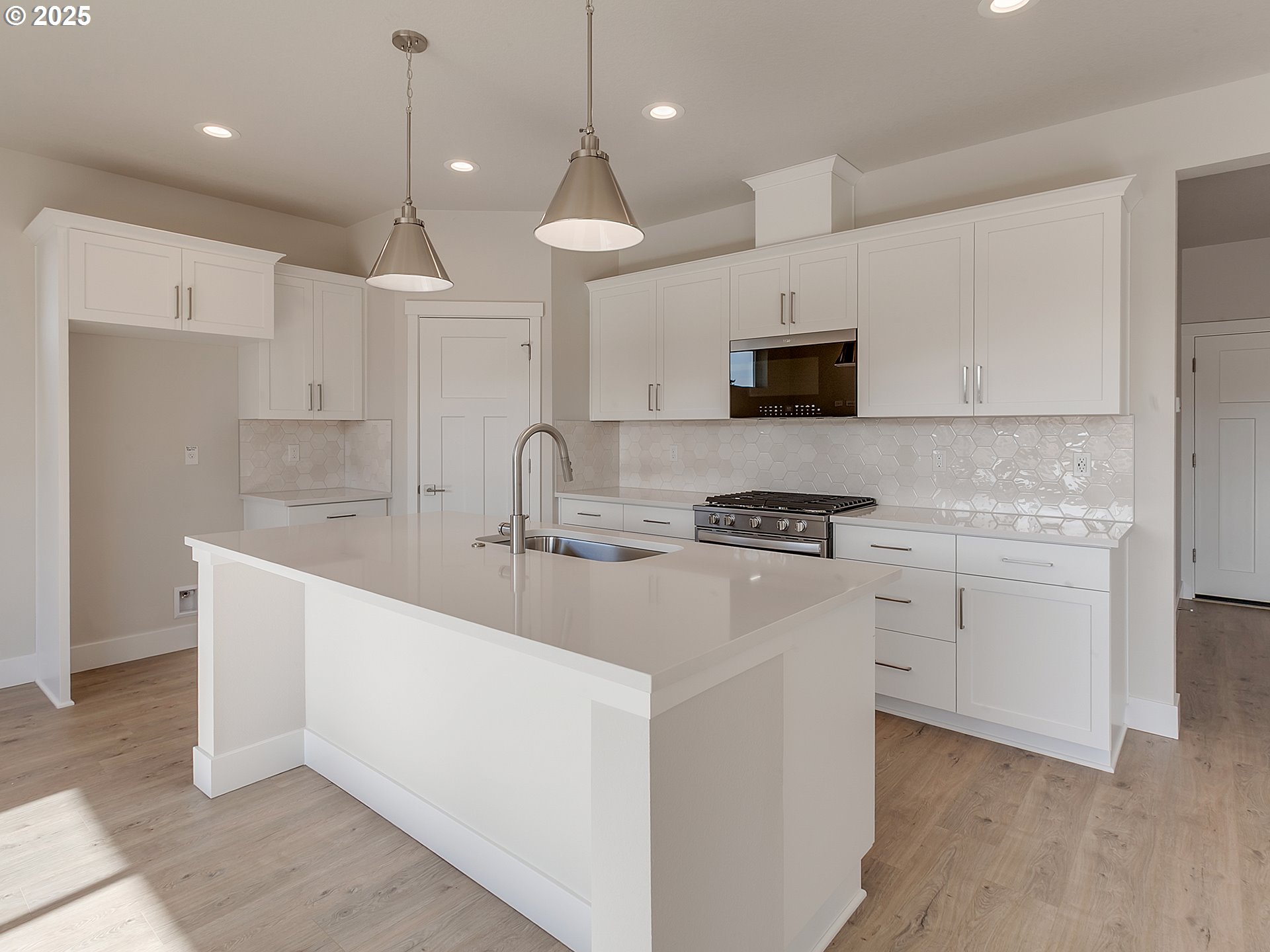 13858 Southwest 174th Avenue Tigard, OR 97140 - Photo 9 of 44 a kitchen with stainless steel appliances granite countertop a sink a stove a refrigerator and white cabinets