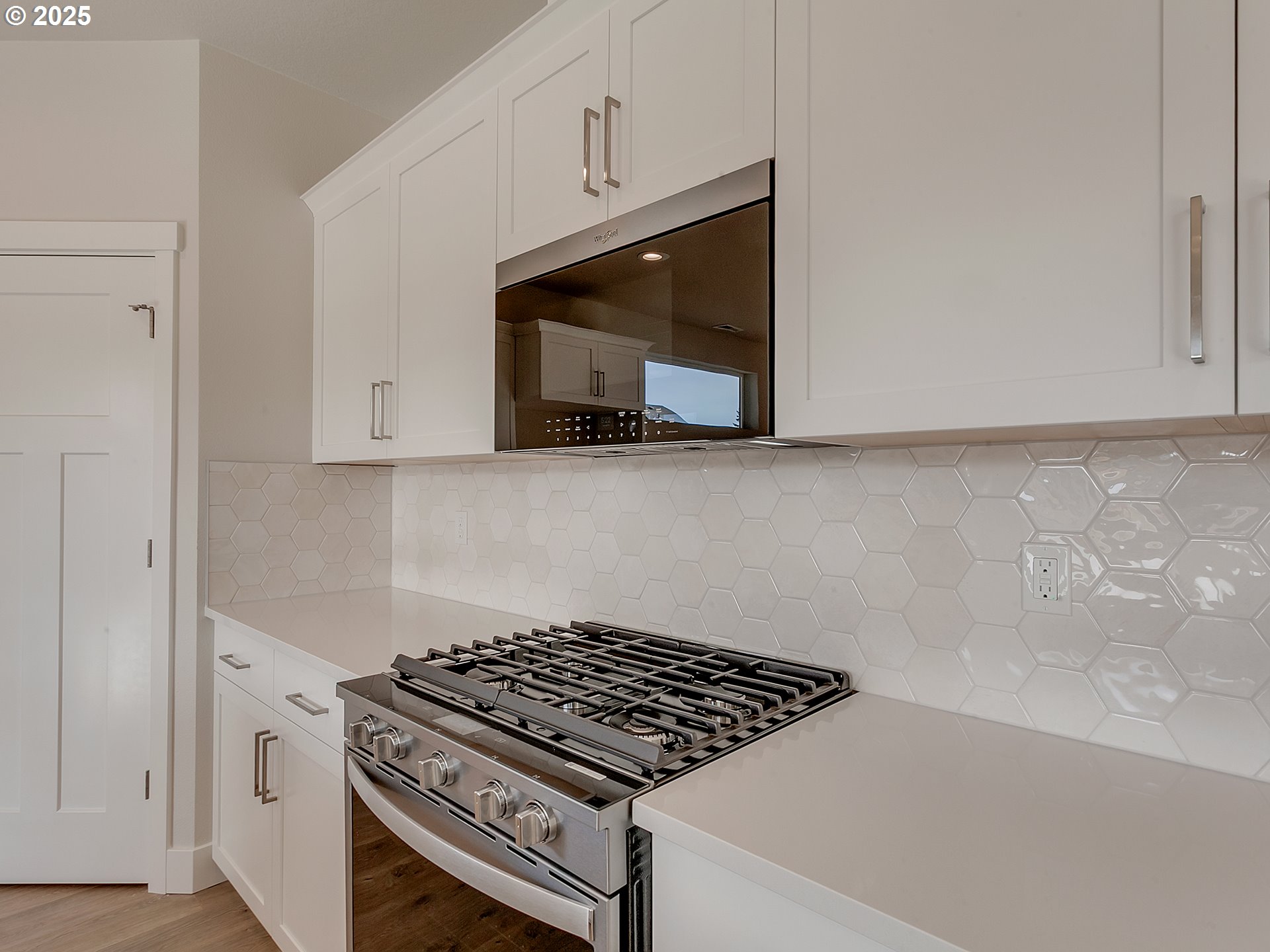 13858 Southwest 174th Avenue Tigard, OR 97140 - Photo 10 of 44 a kitchen with wooden cabinets and a stove top oven