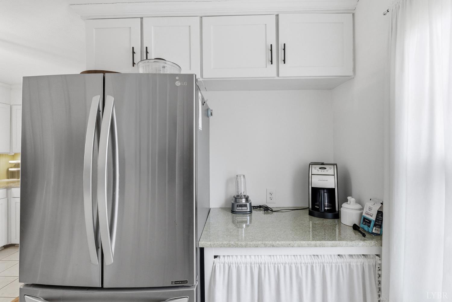 3189 Wildway Road Appomattox, VA 24522 - Photo 13 of 44 a bathroom with a granite countertop sink and refrigerator