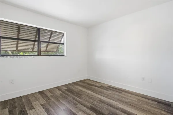 a view of a room with wooden floor