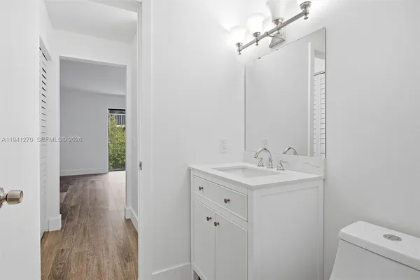 a bathroom with a toilet a sink and mirror