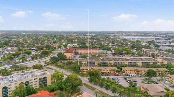 an aerial view of residential building with green space