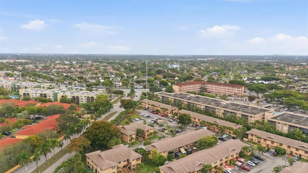 an aerial view of residential houses with city view