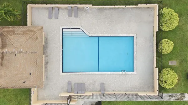 a view of a house with pool and sitting area