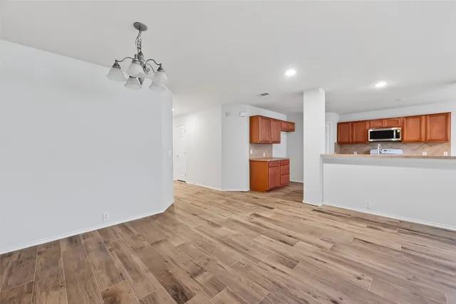 a view of a kitchen with a sink and a refrigerator