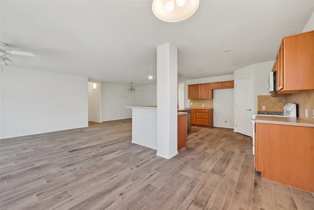 a kitchen with stainless steel appliances a stove microwave and sink