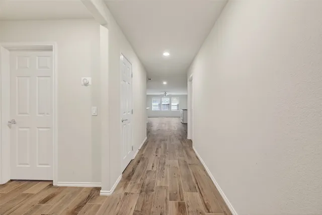 wooden floor in an empty room with a window