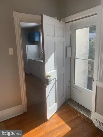 a view of an empty room with a fireplace and a window