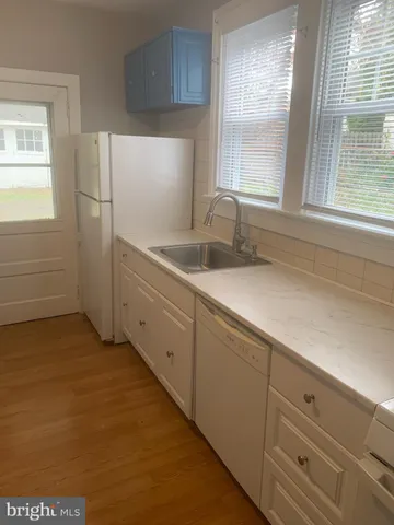 a kitchen with cabinets and window