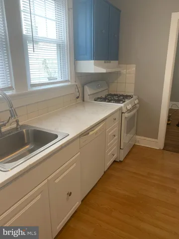 a kitchen with a sink cabinets and window