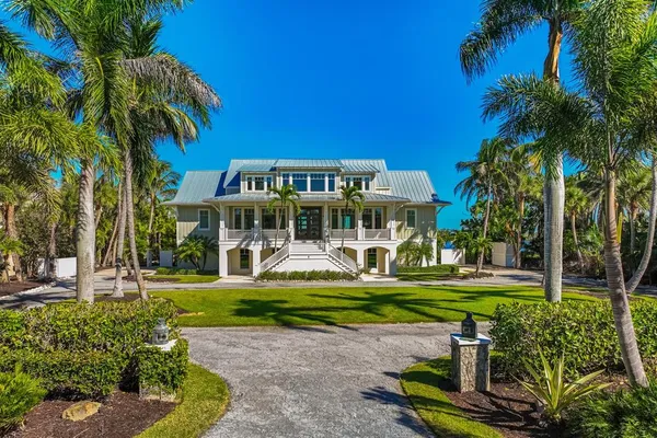 a front view of a house with a yard table and chairs