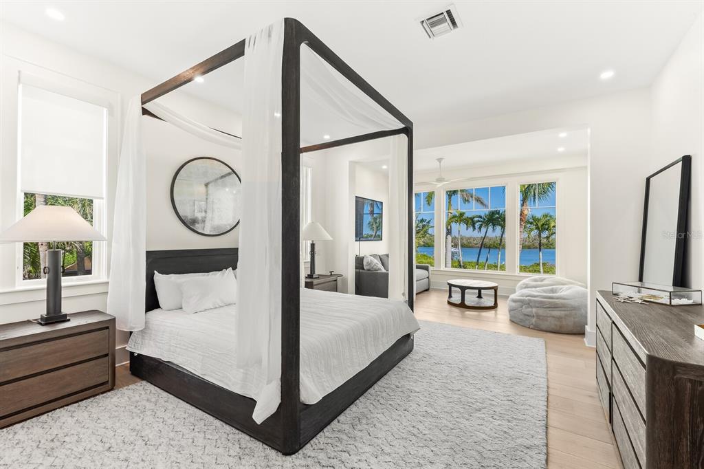 4070 Loomis Avenue Boca Grande, FL 33921 - Photo 23 of 59 a bed room with a bed a mirror and a large window