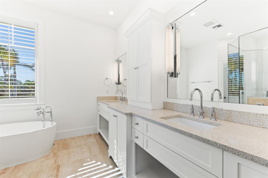 4070 Loomis Avenue Boca Grande, FL 33921 - Photo 29 of 59 a bathroom with a double vanity sink a mirror and a bathtub