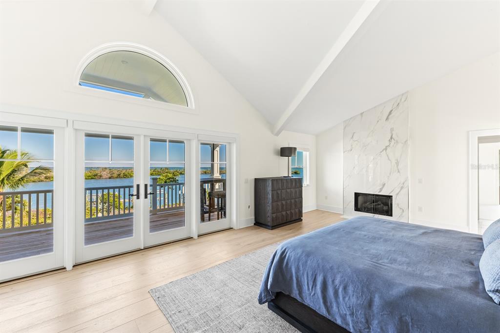 4070 Loomis Avenue Boca Grande, FL 33921 - Photo 31 of 59 a spacious bedroom with a balcony a bed and a large window
