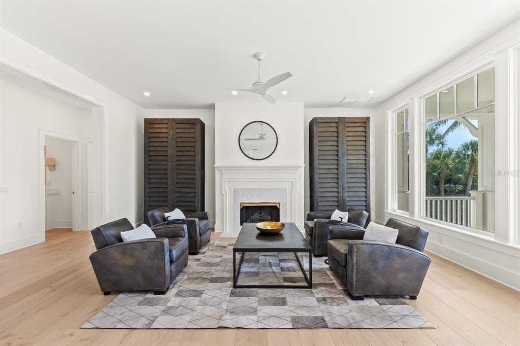 4070 Loomis Avenue Boca Grande, FL 33921 - Photo 9 of 59 a living room with furniture a fireplace and wooden floor