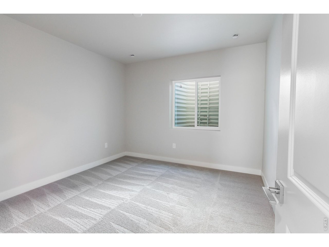 792 Chatter Road Windsor, CO 80550 - Photo 34 of 49 a view of an empty room with a window