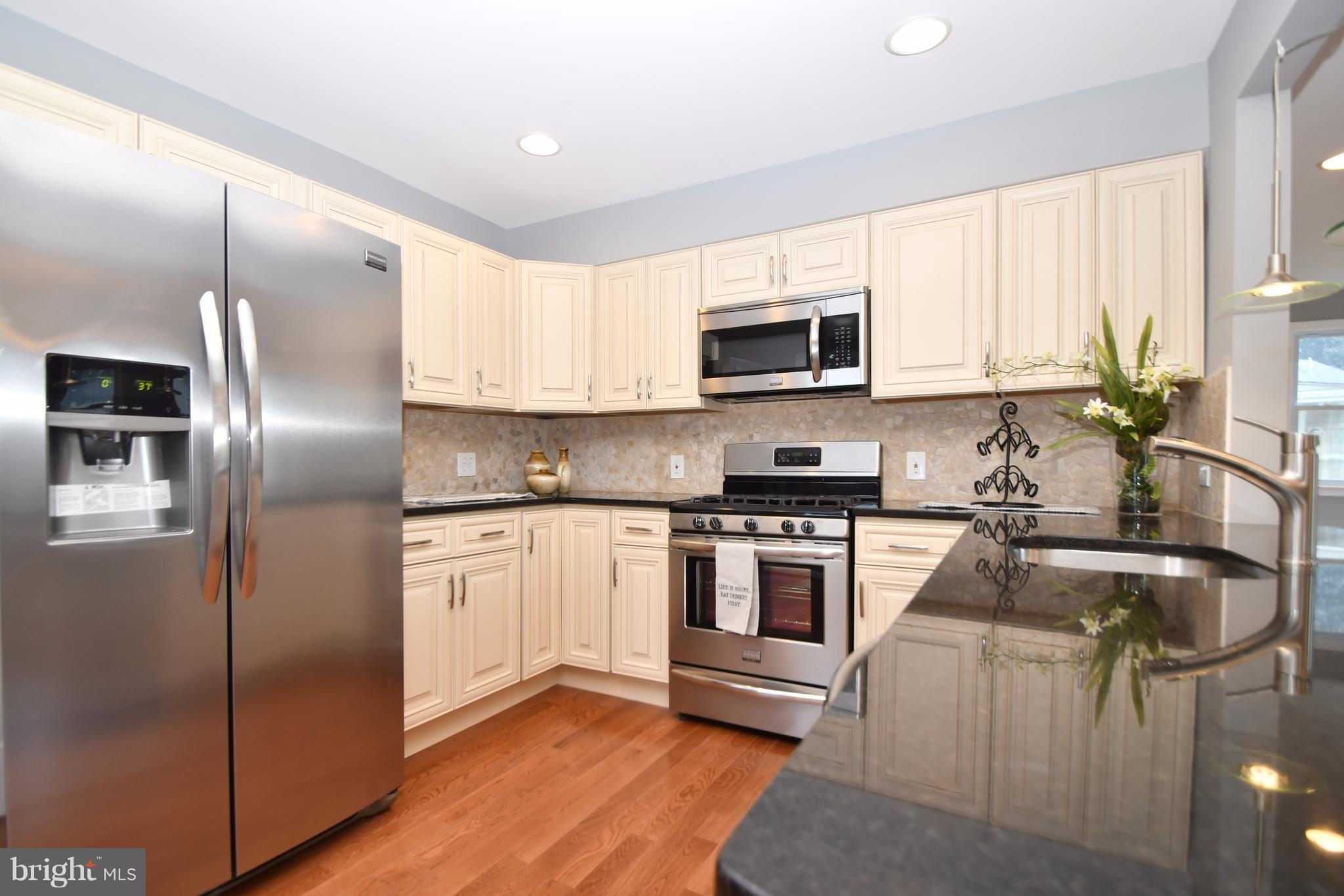 8209 Northview Road Baltimore, MD 21222 - Photo 5 of 30 a kitchen with stainless steel appliances granite countertop a refrigerator a stove a sink and a microwave