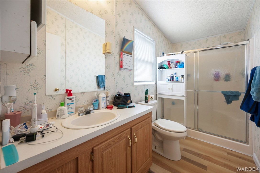 2465 Egar Road Golden Valley, AZ 86413 - Photo 32 of 98 The bathroom features a vanity with a sink, a mirror, and cabinetry below