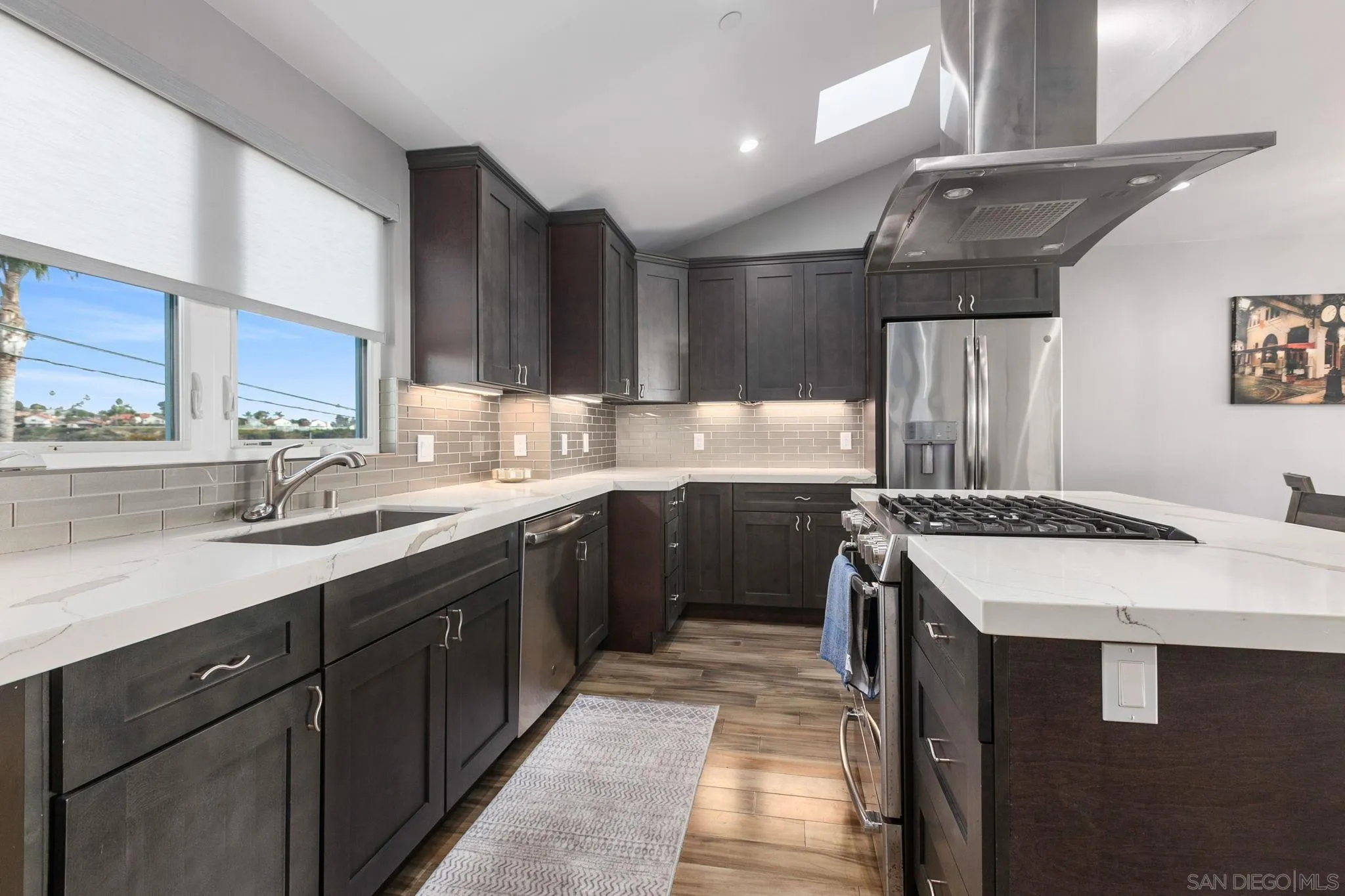 2319 Cambridge Avenue Cardiff, CA 92007 - Photo 29 of 48 a kitchen with a sink stove and cabinets