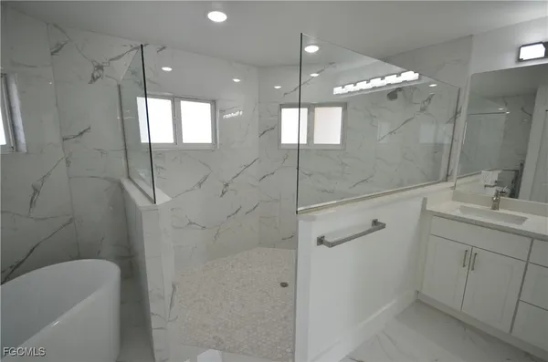 a white bath tub sitting in a bathroom