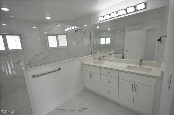 a white toilet sitting next to a bathroom sink