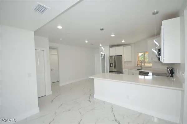 a large room with a sink a mirror and a shower