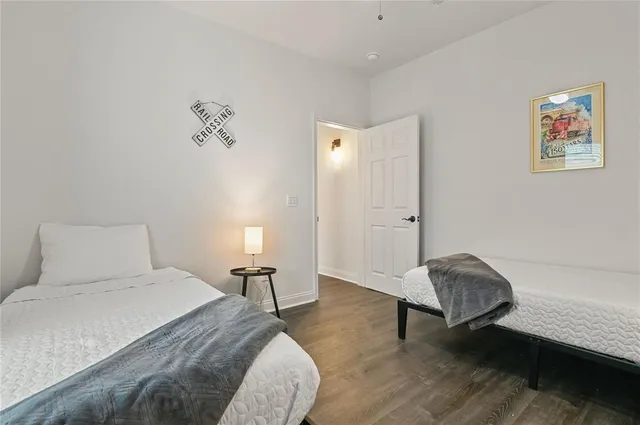 a bedroom with a bed and a lamp