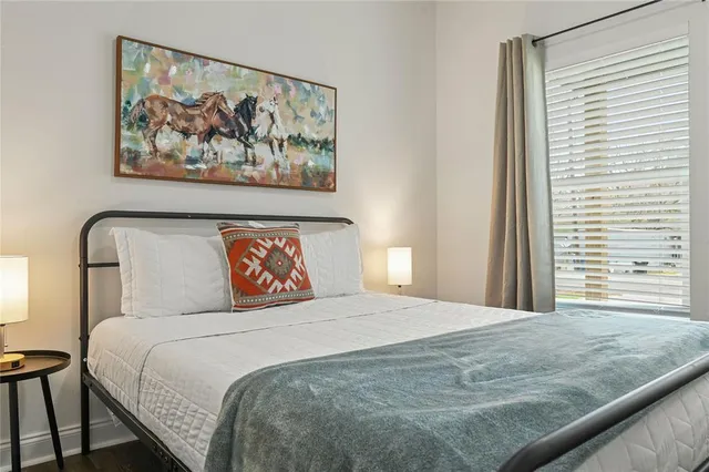 a bedroom with a bed and a painting on the wall