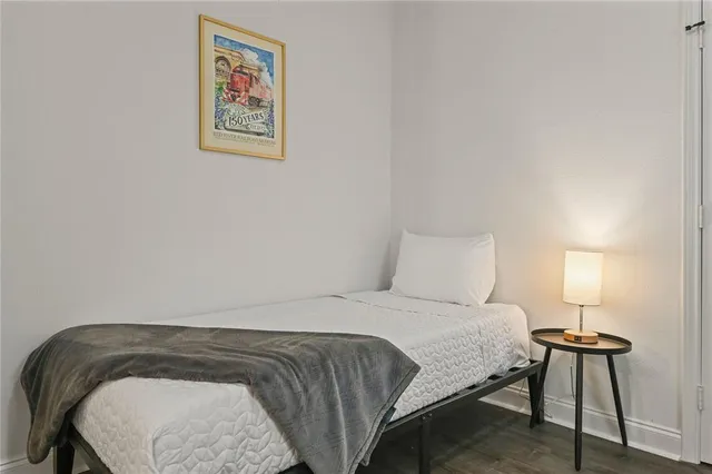 a bedroom with a bed and a lamp