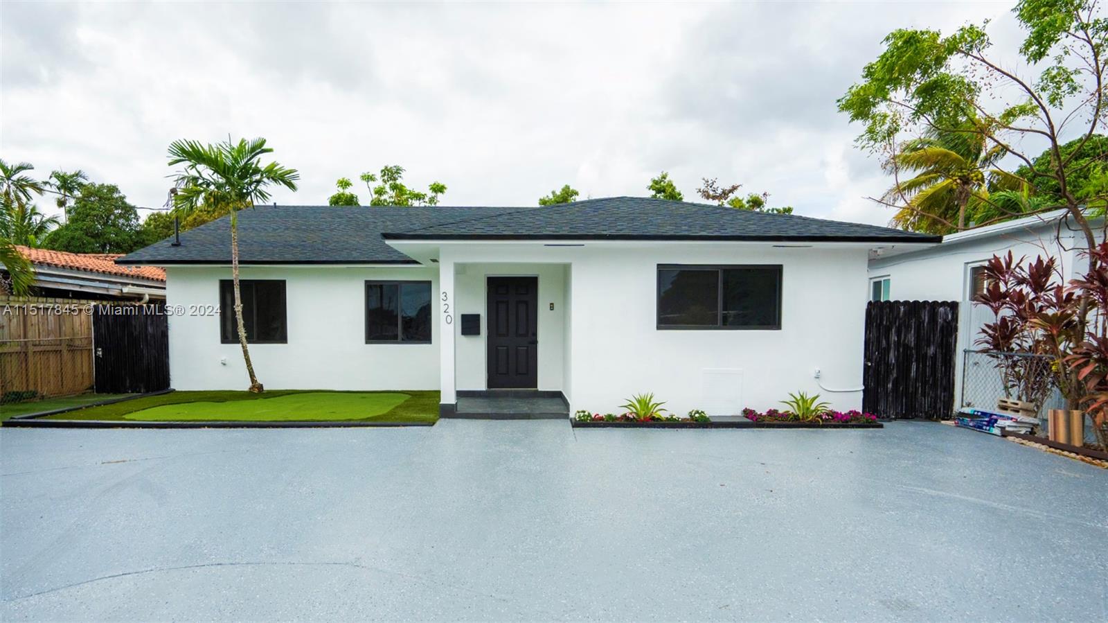 320 Southwest 66th Avenue Miami, FL 33144 - Photo 1 of 24 a front view of a house with a garage