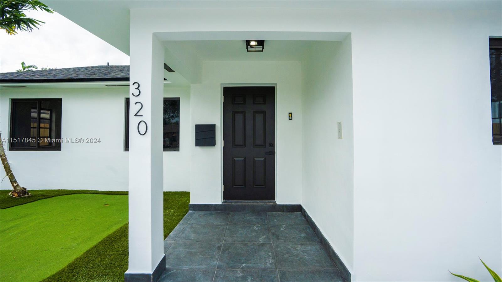 320 Southwest 66th Avenue Miami, FL 33144 - Photo 3 of 24 a front view of a house with a garden