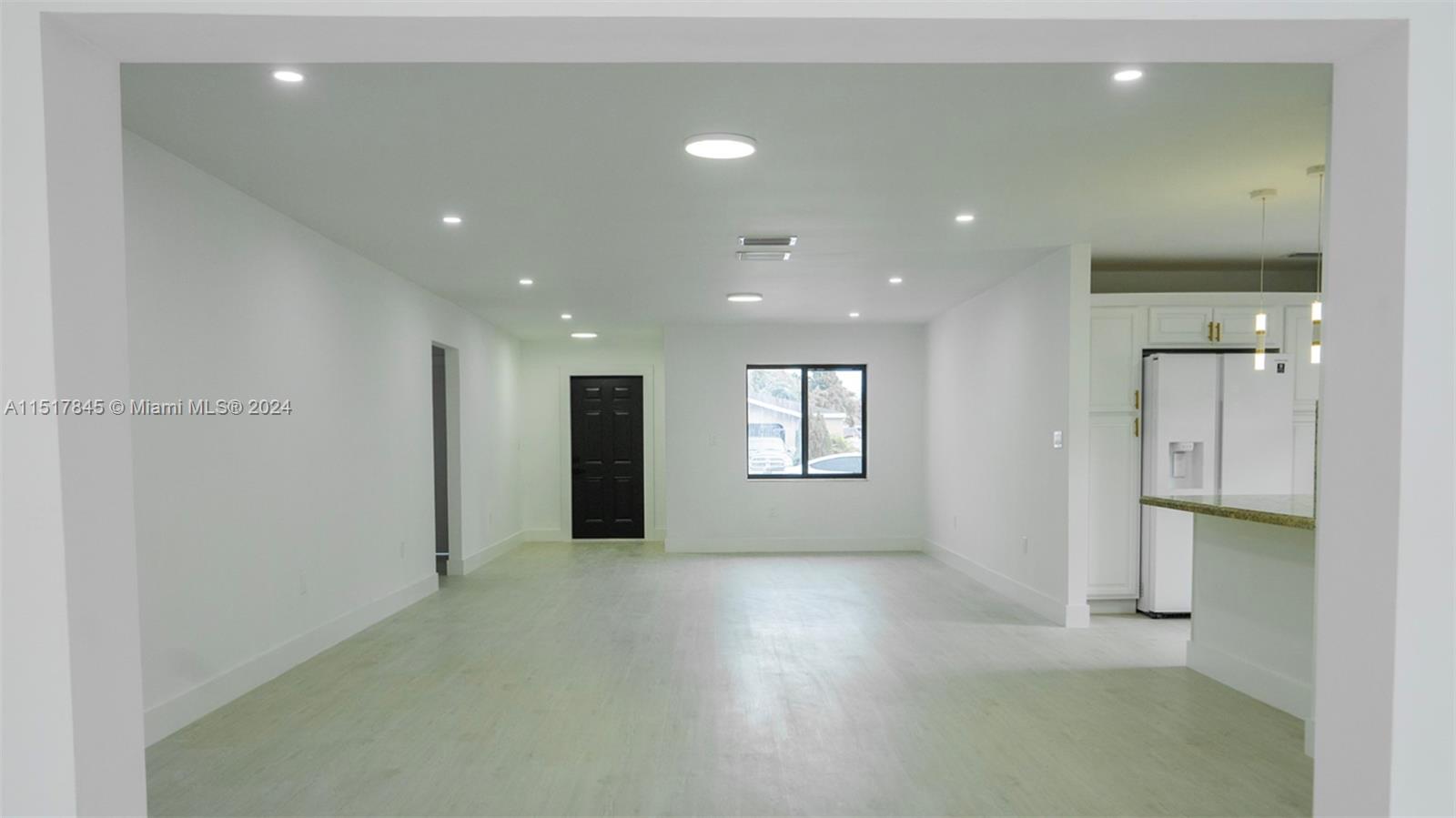 320 Southwest 66th Avenue Miami, FL 33144 - Photo 6 of 24 an empty room with windows and a ceiling fan