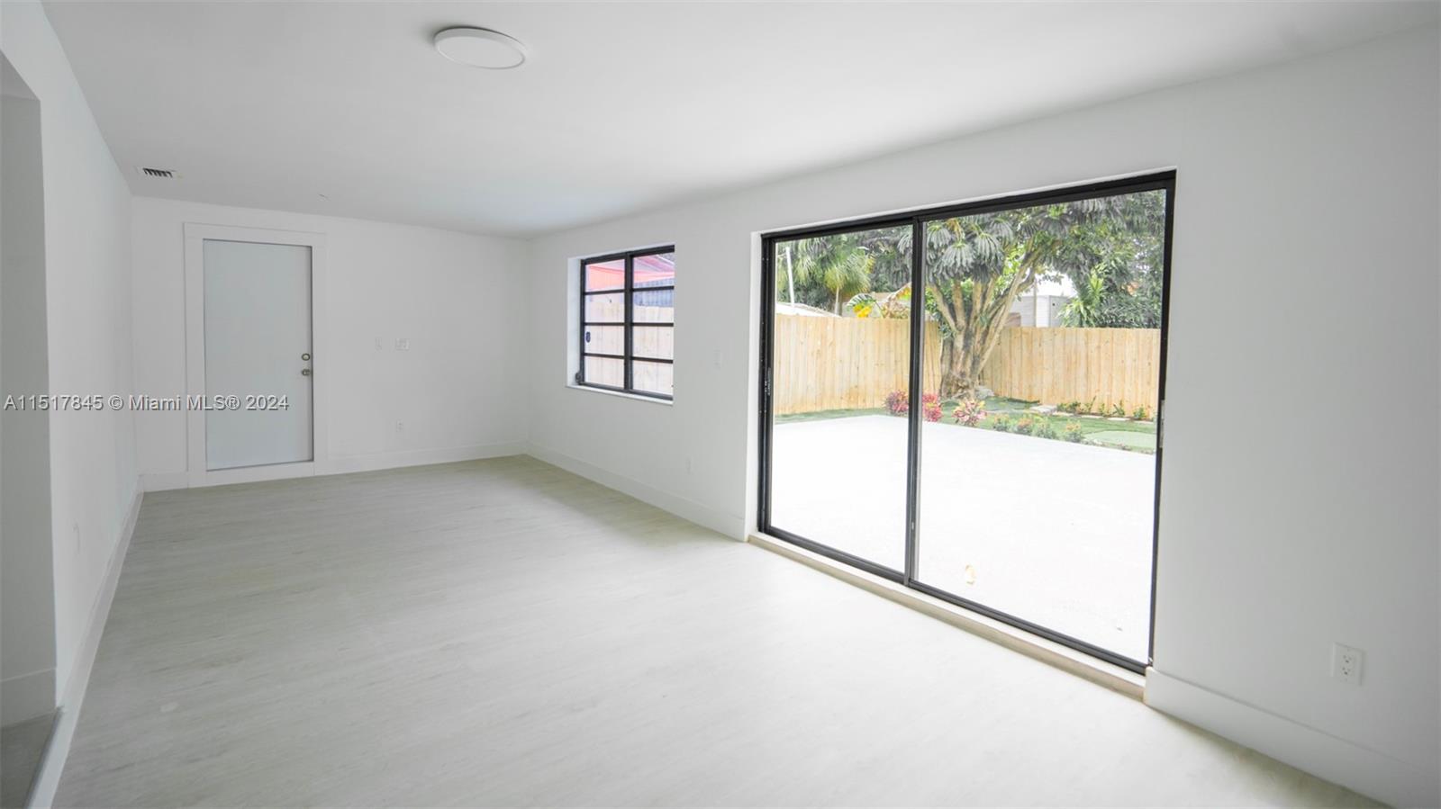 320 Southwest 66th Avenue Miami, FL 33144 - Photo 7 of 24 wooden floor in an empty room with a window