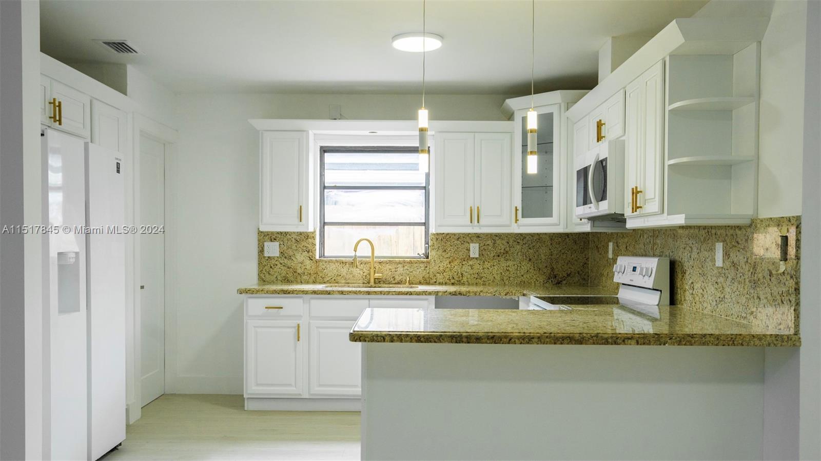 320 Southwest 66th Avenue Miami, FL 33144 - Photo 8 of 24 a kitchen with stainless steel appliances granite countertop a sink a stove and a refrigerator