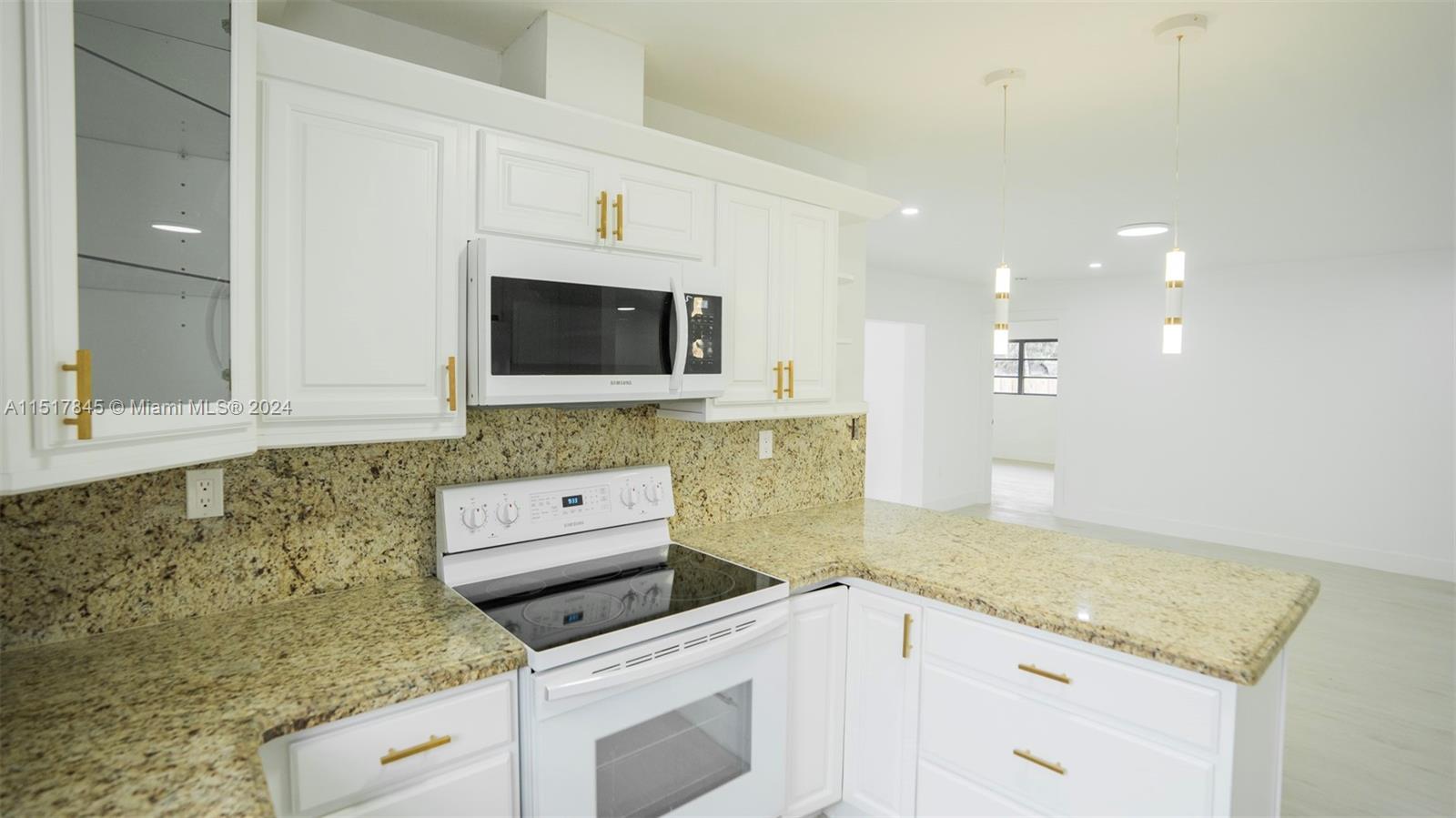 320 Southwest 66th Avenue Miami, FL 33144 - Photo 9 of 24 a kitchen with granite countertop a sink stove and microwave