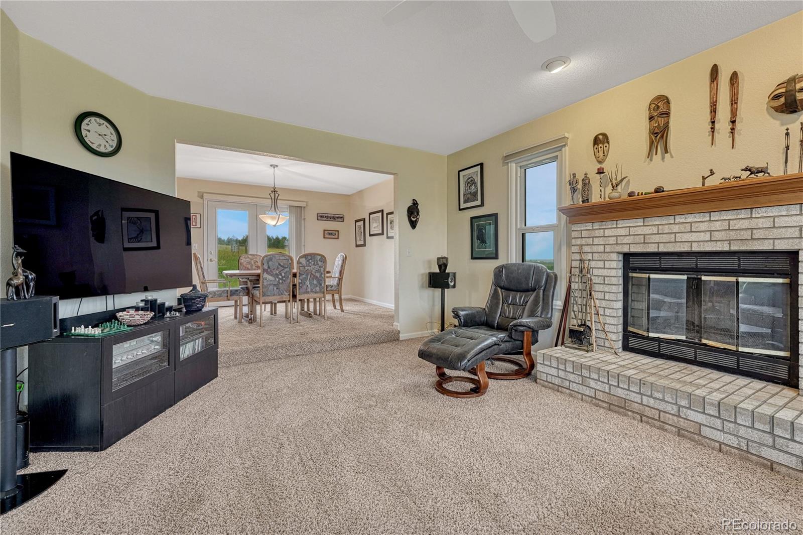 43793 Buckskin Road Parker, CO 80138 - Photo 11 of 50 a living room with furniture flat screen tv and a fireplace